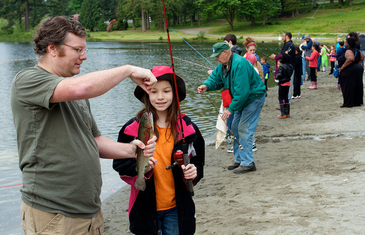 Silver Lake in Everett, shown here during a spring fish-in for kids, will be among the lakes planted with fish in an effort to attract anglers over the Thanksgiving holiday. (Photo by Mike Benbow)