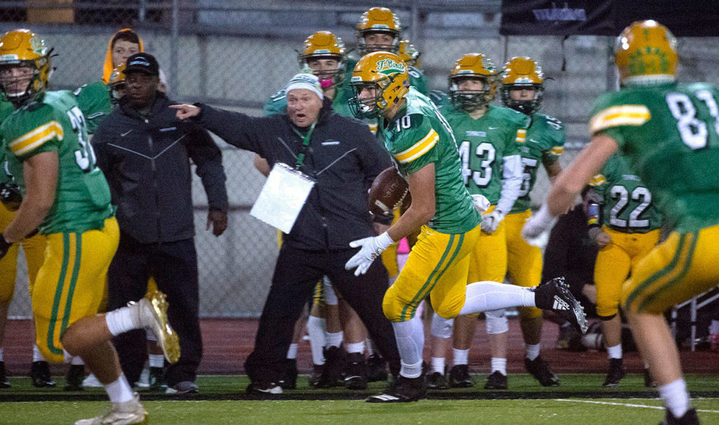 Tumwater defensive end Ryan Otton (center) returns an interception during a 2A state playoff game against Franklin Pierce on Nov. 15 at Tumwater District Stadium. (Tony Overman / The Olympian)
