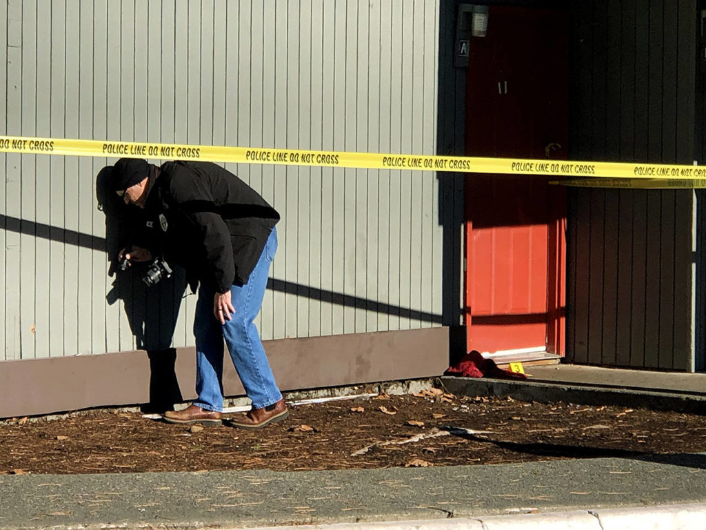 Police searched for evidence Thursday morning at the scene of a shooting that wounded four people in south Everett on Wednesday. (Andy Bronson / The Herald)
