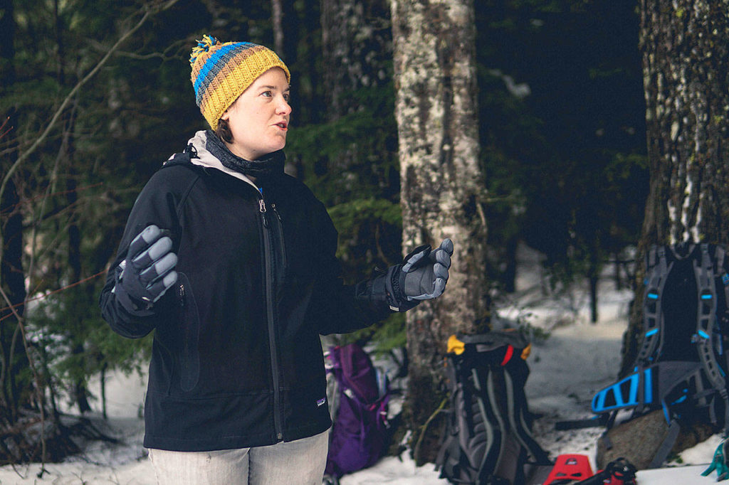 Jean Bartholomew, an Outdoor Leadership Training administration coordinator, talks to adults who work with youth about the skills they need to get kids outside during a snowshoe workshop at Gold Creek. (Britt Lê)
