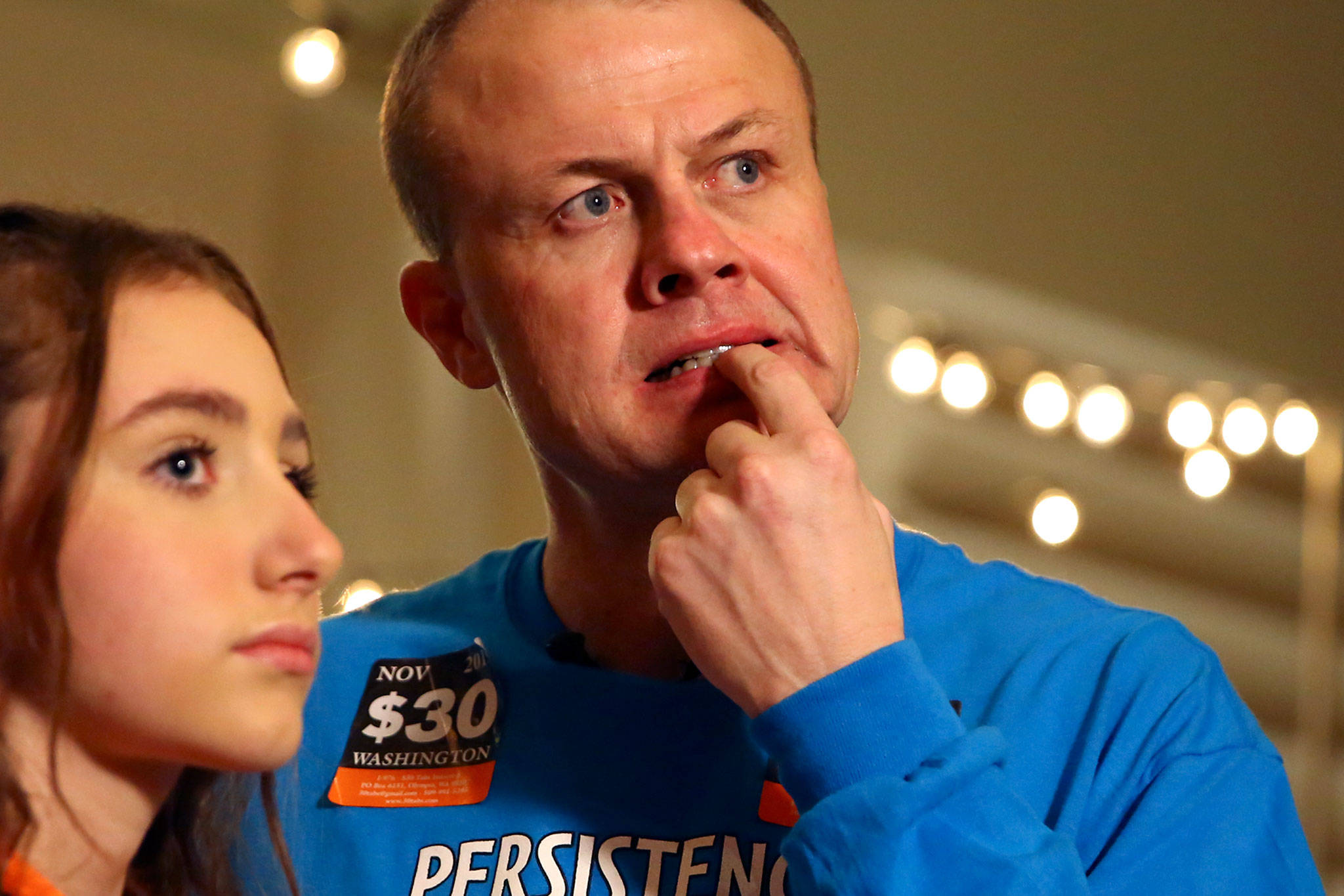 Tim Eyman (right) with his daughter, Riley Eyman, react to the early numbers for Initiative 976 on Nov. 5 in Bellevue. (Kevin Clark / The Herald)