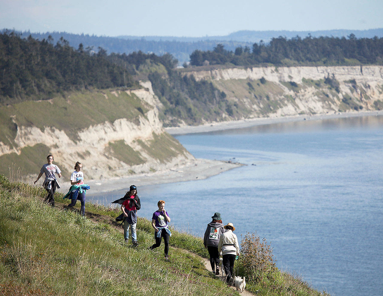 Hikers make their way along the Bluff Trail at Ebey’s Landing National Historical Preserve near Coupeville on Whidbey Island in April, 2015. At its highest point, the bluff sits about 260 feet above sea level providing stunning views of the Puget Sound and beyond. (Ian Terry / Herald file photo)