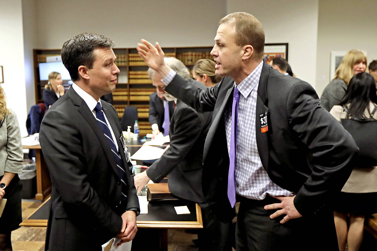 Tim Eyman (right) a career anti-tax initiative promoter, argues with Noah Purcell, solicitor general of the state of Washington, following a King County Superior Court hearing Tuesday in Seattle. (AP Photo/Ted S. Warren)
