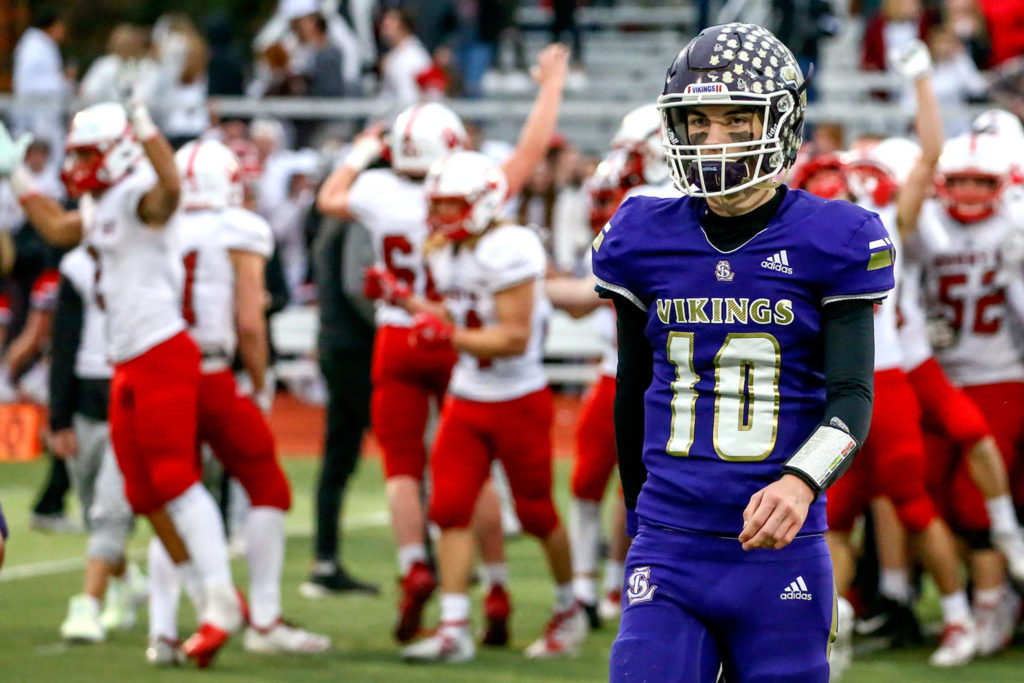 Lake Stevens quarterback Tanner Jellison walks of the field as Mount Si players celebrate after the Wildcats beat the Vikings 24-22 in a 4A state quarterfinal game on Saturday afternoon at Lake Stevens High School. (Kevin Clark / The Herald)
