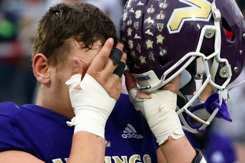 Lake Stevens’ Cameron Hunter walks off the field dejected after losing to Mount Si Saturday afternoon at Lake Stevens High School on November 23, 2019. Lake Stevens lost to Mount Si, 24-22, ending their state championship run. (Kevin Clark / The Herald)
