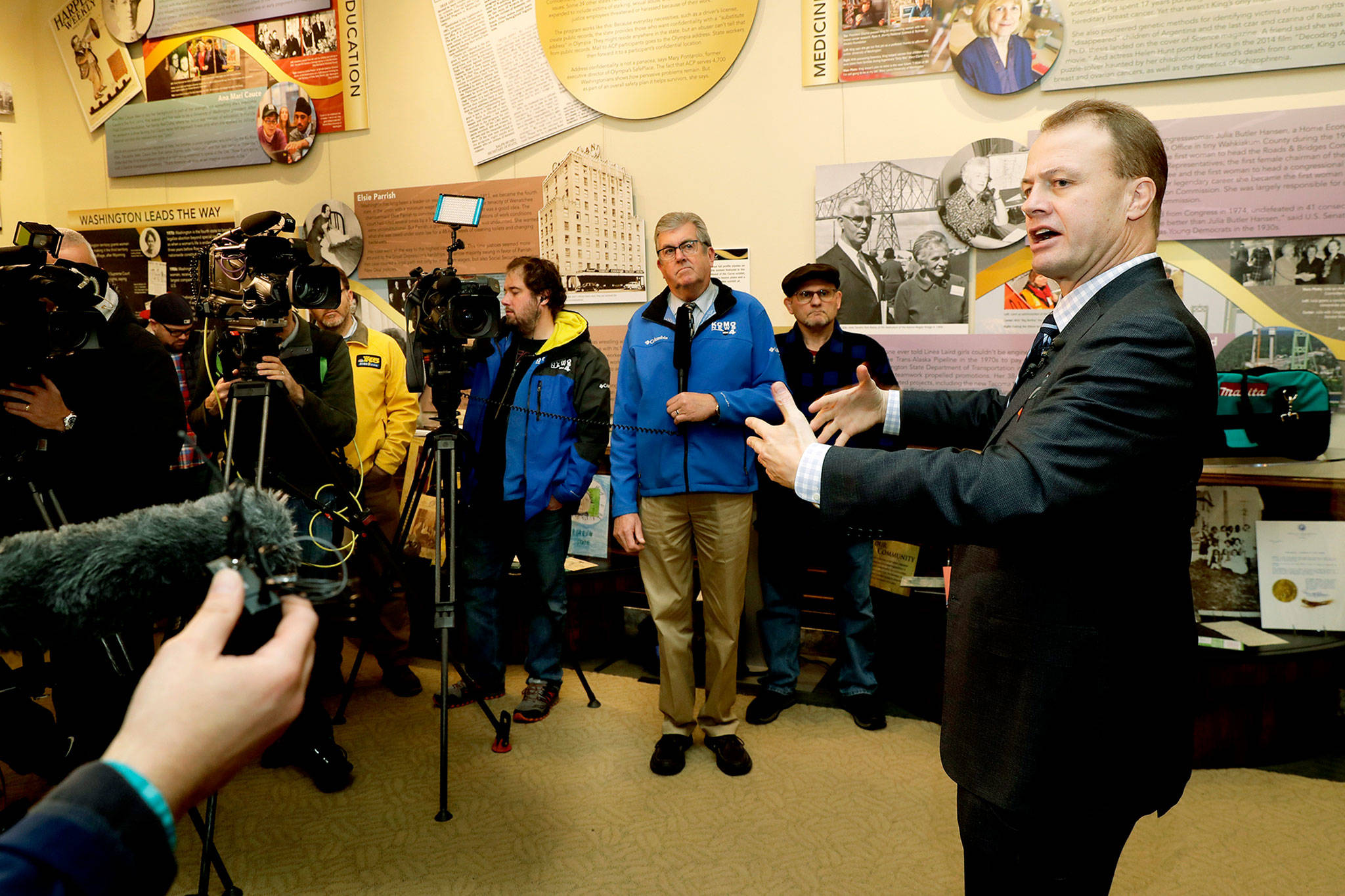 Tim Eyman (right), a career anti-tax initiative promoter, talks to reporters Monday at the Capitol in Olympia. He was there to officially announce his entry in the 2020 governor’s race, as an independent. (AP Photo/Ted S. Warren)