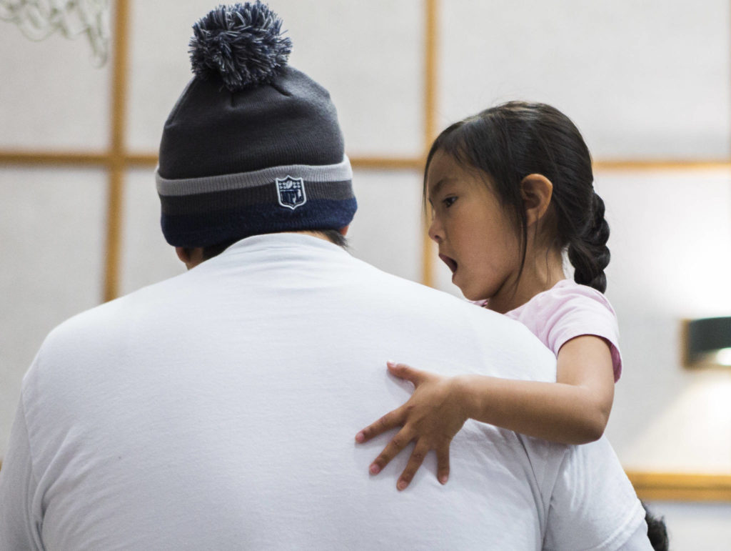 Tehya Robinson, 5, sings while her father Marc Robinson drums during Tulalip Day at Quil Ceda Tulalip Elementary on Wednesday in Tulalip. (Olivia Vanni / The Herald)
