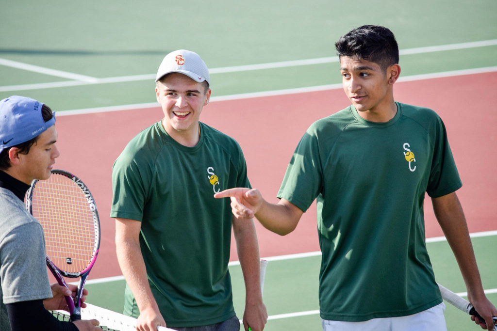 Shorecrest’s Ben Silber (middle) and Zaid Khan (right) talk to their opponents, Shintaro Wilcox and Preston Pierce, from Stanwood after winning the 3A Northwest District Tournament doubles final Oct. 30 at Arlington High School. (Katie Webber / The Herald)
