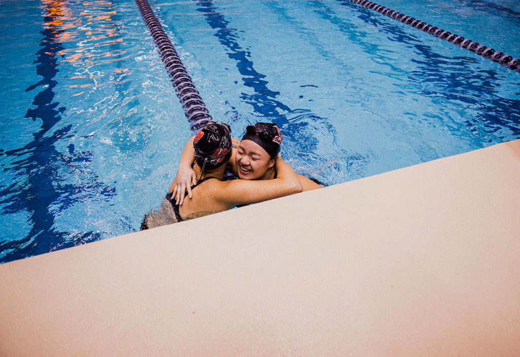 Stanwood’s Jetlynn Hau hugs Snohomish’s Mieko Schwartzmiller after their 100 yard breaststroke race during the WIAA 2018 State Swim & Dive Championships on Saturday, Nov. 10, 2018 in Federal Way, Wa. (Olivia Vanni / The Herald)
