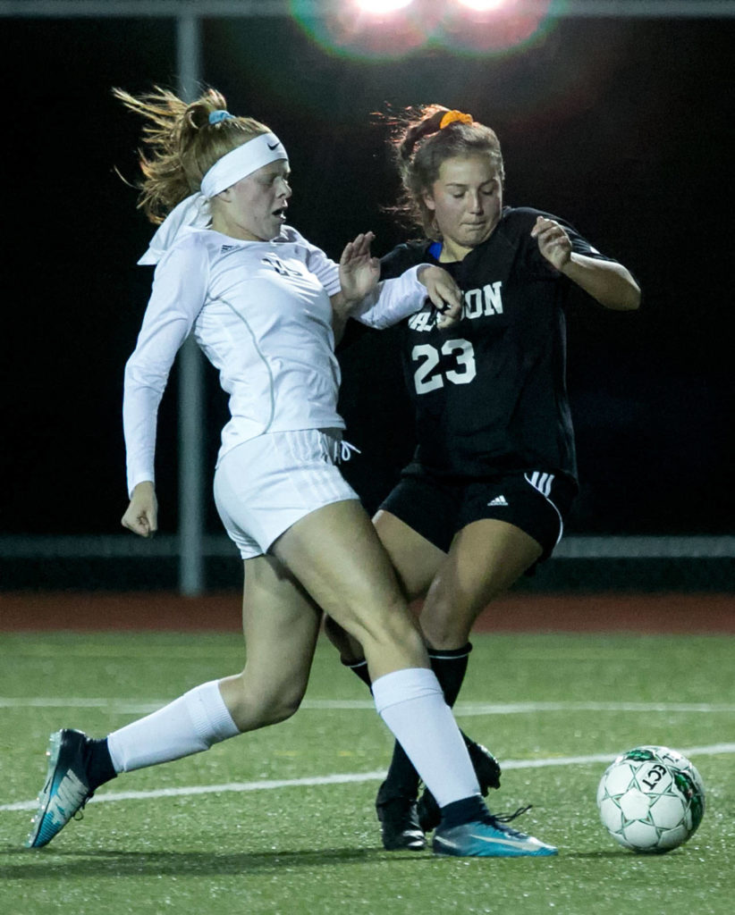 Lake Stevens’ Mackenzie Delgado (left) and Jackson’s Gabriela Franco vie control Thursday night at Everett Memorial Stadium on October 25, 2018. (Kevin Clark / The Herald)
