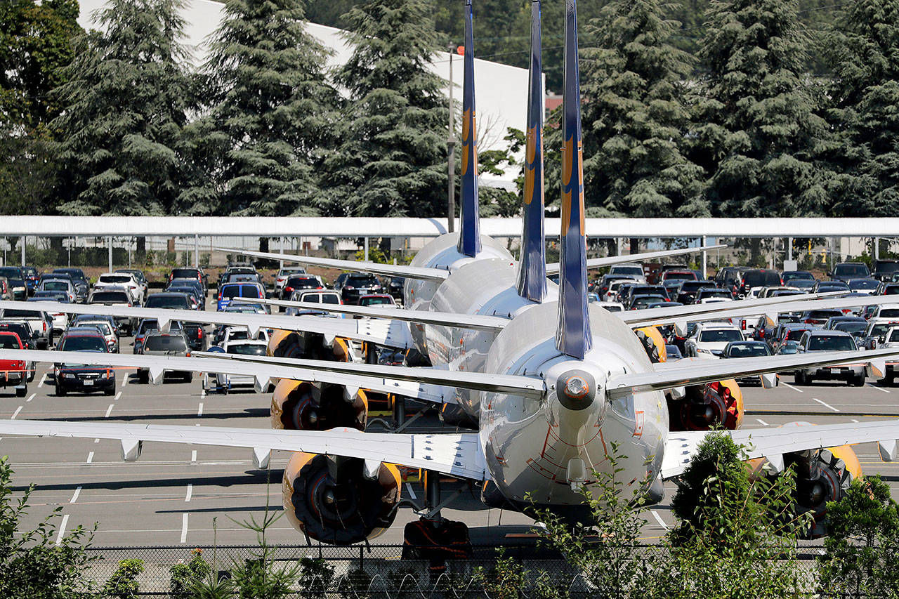 Grounded Boeing 737 Max airplanes are parked in a lot normally used for cars near Boeing Field, in Seattle in August. (AP Photo/Elaine Thompson, File)