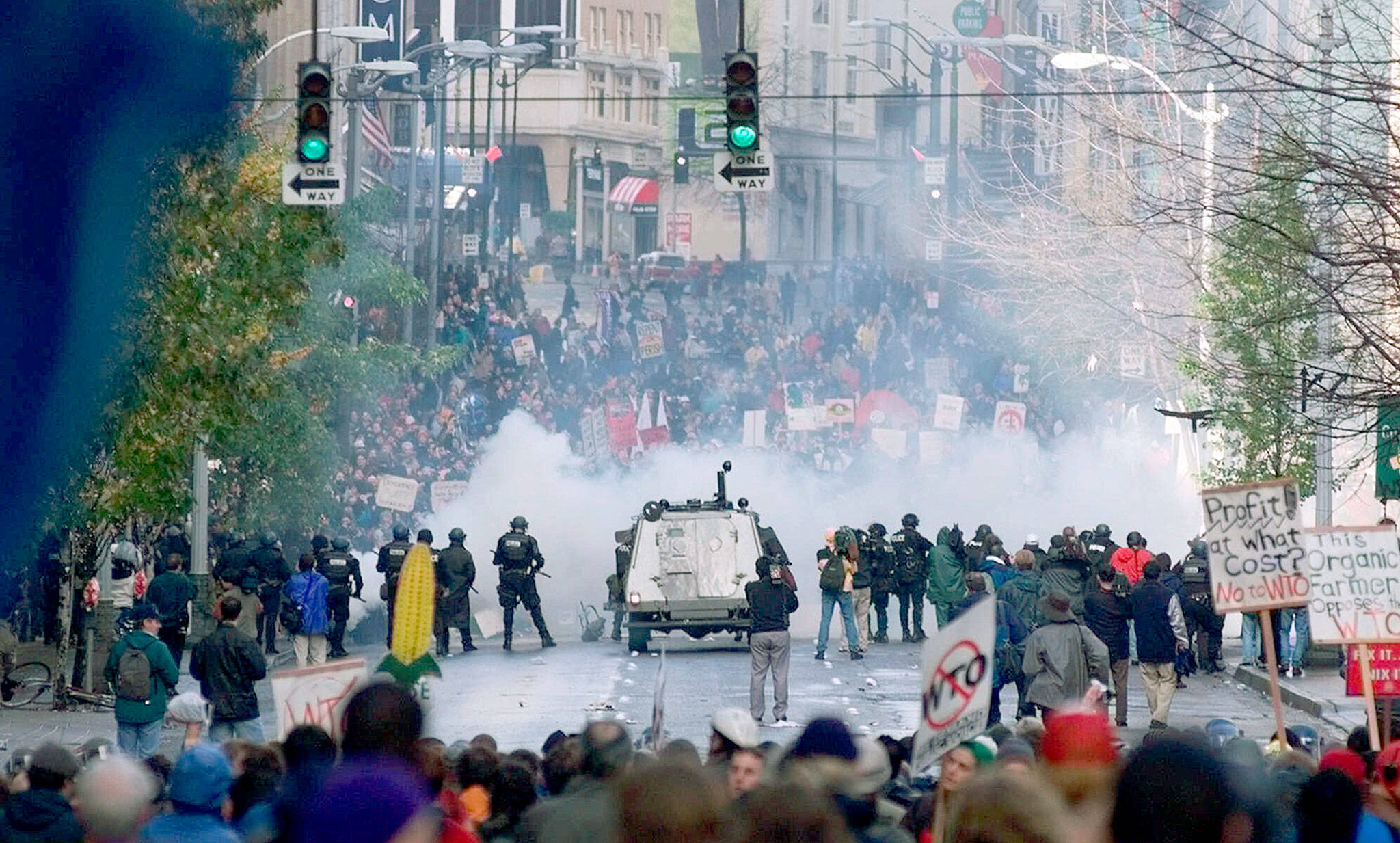 On Nov. 30 1999, Seattle police use tear gas to push back World Trade Organization protesters downtown. Saturday marks 20 years since tens of thousands of protesters converged on Seattle and disrupted a major meeting of the World Trade Organization. Two decades later, many of their causes are still relevant. (AP Photo/Eric Draper, File)