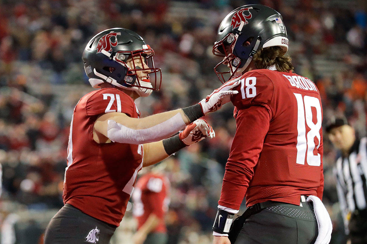 Washington State running back Max Borghi (left) celebrates with quarterback Anthony Gordon after Borghi scored a touchdown against Oregon State during the second half of an NCAA college football game, Saturday, Nov. 23, 2019, in Pullman, Wash. Washington State won 54-53. (AP Photo/Ted S. Warren)