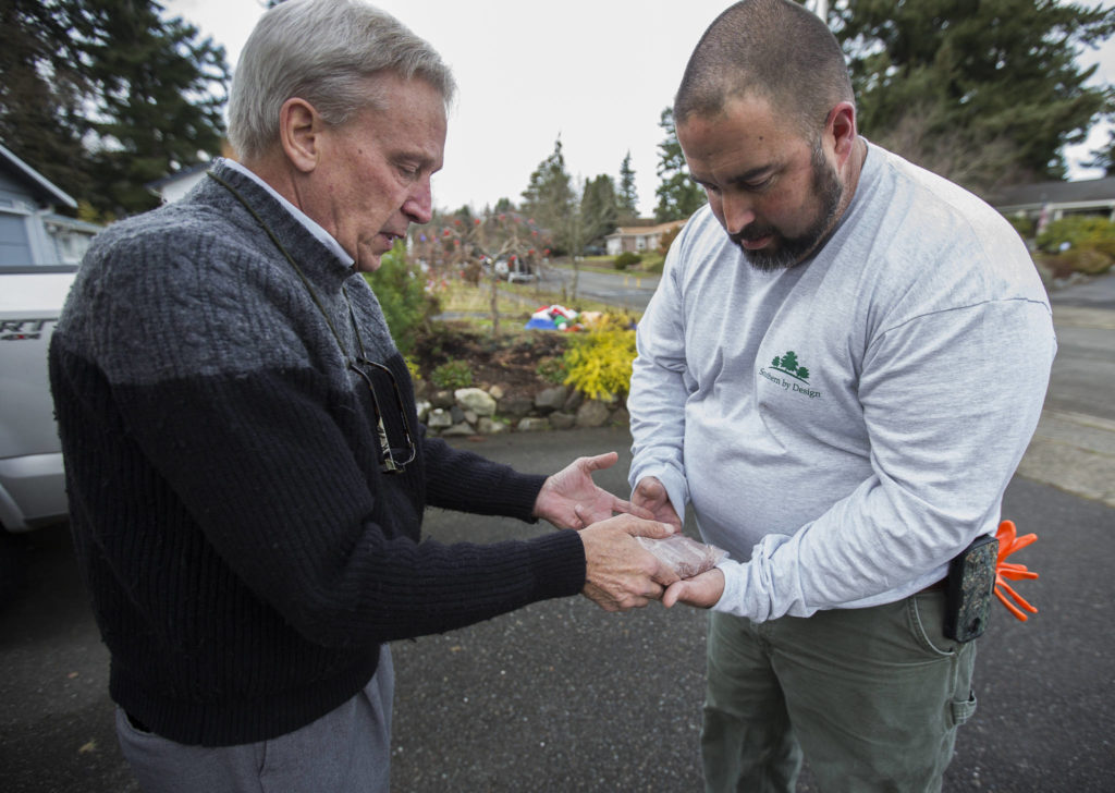 David Haarsager (left) hands Sprite’s paw impression to her owner, Wesley Clement. (Olivia Vanni / The Herald)
