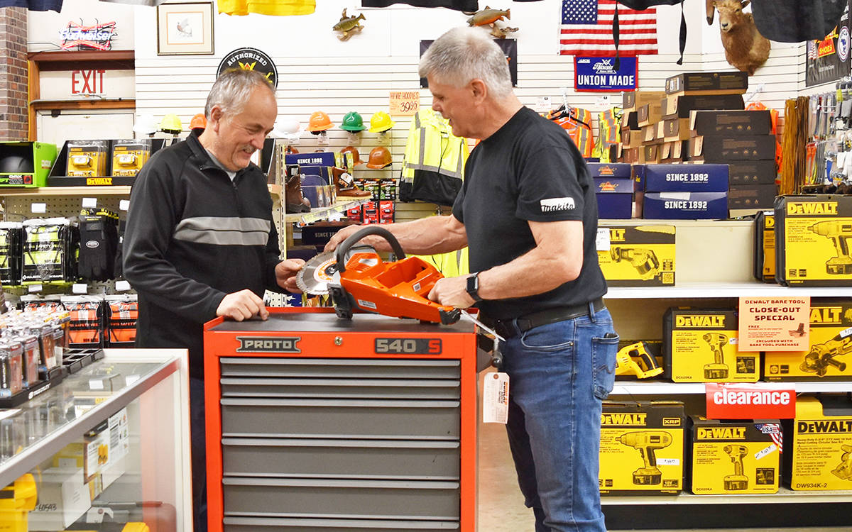 Dunlap Industrial General Manager Rich Barnett (right) and sales associate Doug Dowd check out a new Husqvarna diamond blade power cut cordless saw in the store in Everett. Dunlap offers a multitude of commercial grade tools and equipment that help you complete the task at hand on the jobsite or at home.
