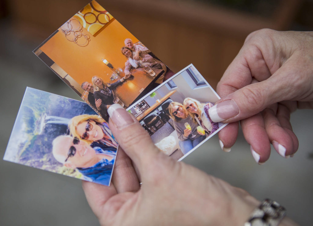 Howell carries around three small photos of herself and her half-sister Linda Holt from the day in October that they met. (Olivia Vanni / The Herald)

