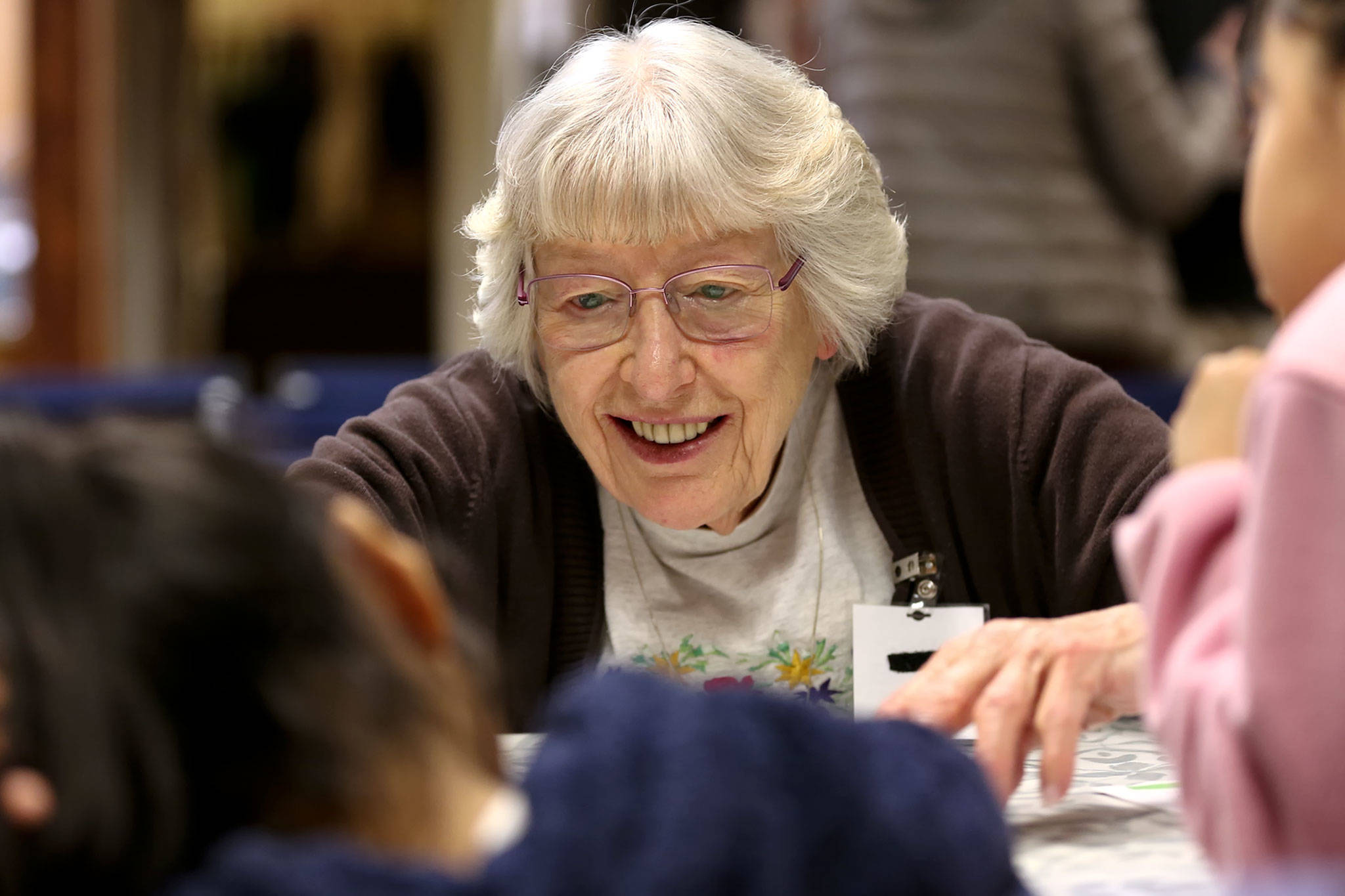 Margaret Ray helps students with worksheets in Monroe on Nov. 19. (Kevin Clark / The Herald)