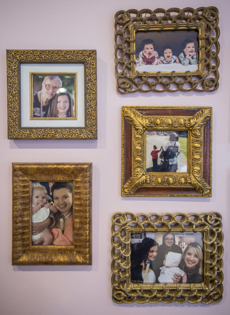 Photos of family and friends hang on Loa Griesbach’s bedroom wall at her home in Everett. A favorite is of her nephew Porter Taylor Newell, 2, holding her hand while he walks along next to her. (Olivia Vanni / The Herald)
