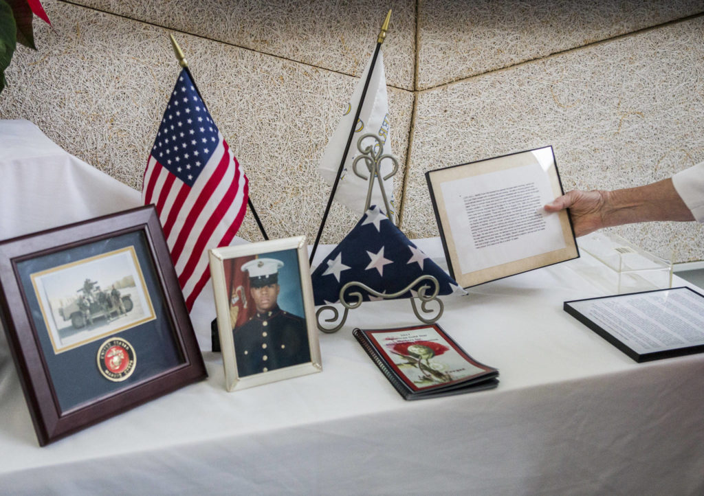 Myra Rintamaki sets up the American Gold Star Mothers’ remembrance table before the start of the Hero’s Cafe at the Verdant Community Wellness Center on Nov. 26. (Olivia Vanni / The Herald)

