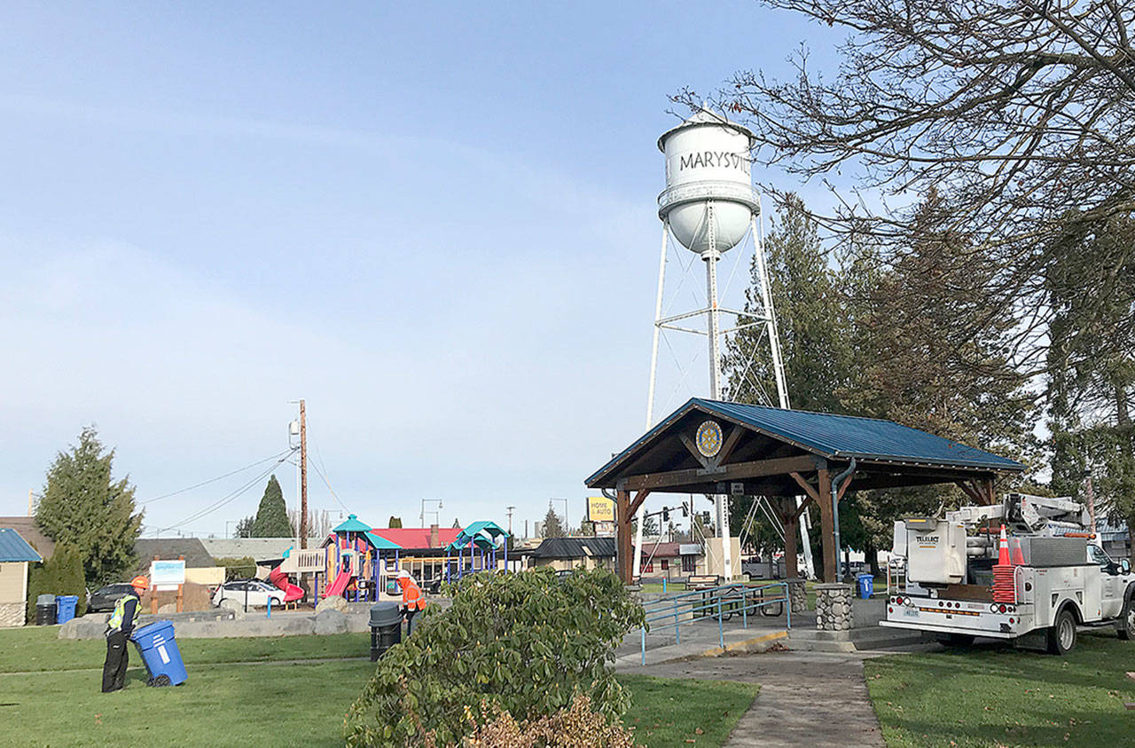 Crews hang up lights in November at the gazebo in Comeford Park, as the Marysville water tower looms in the background. It won’t be lit up this year for the holidays, after almost a quarter-century. (Stephanie Davey / The Herald)