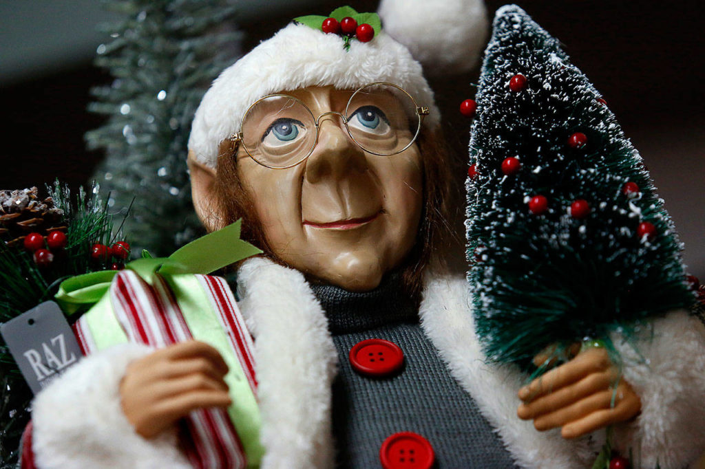 At Hilton Pharmacy & Gifts, Christmas elves appear to enjoy people watching, mostly from perches nearer the overhead lighting. (Dan Bates / The Herald)

