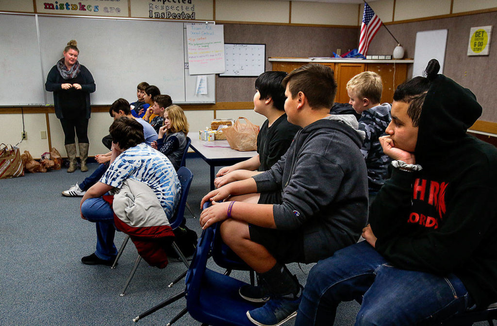 North Lake Middle School teacher Ange Kendall (left) addresses students in her Social Skills class. On Wednesday the students sorted grocery items that they delivered Thursday to the Lake Stevens Community Food Bank. (Dan Bates / The Herald)
