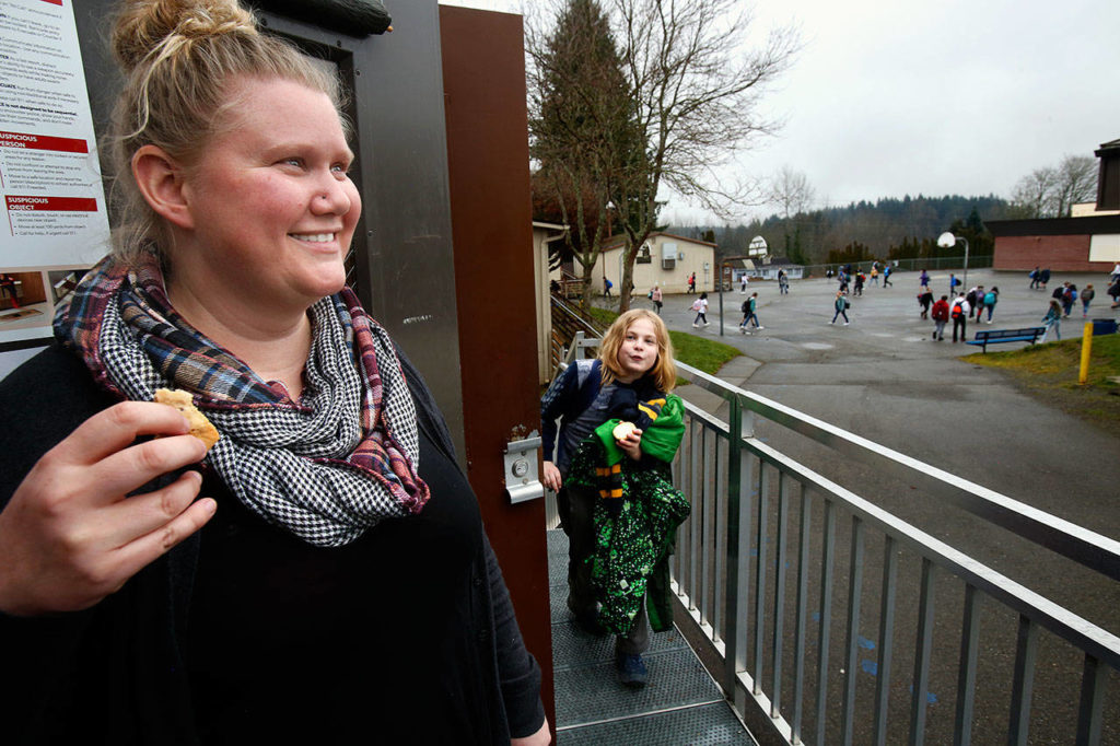 North Lake Middle School teacher Ange Kendall has a big smile at the end of class Wednesday, while Duvaekk Smith, 11, says goodbye. The sixth-grader is part of Kendall’s Social Skills class that is helping supply the Lake Stevens Community Food Bank this holiday season. (Dan Bates / The Herald)
