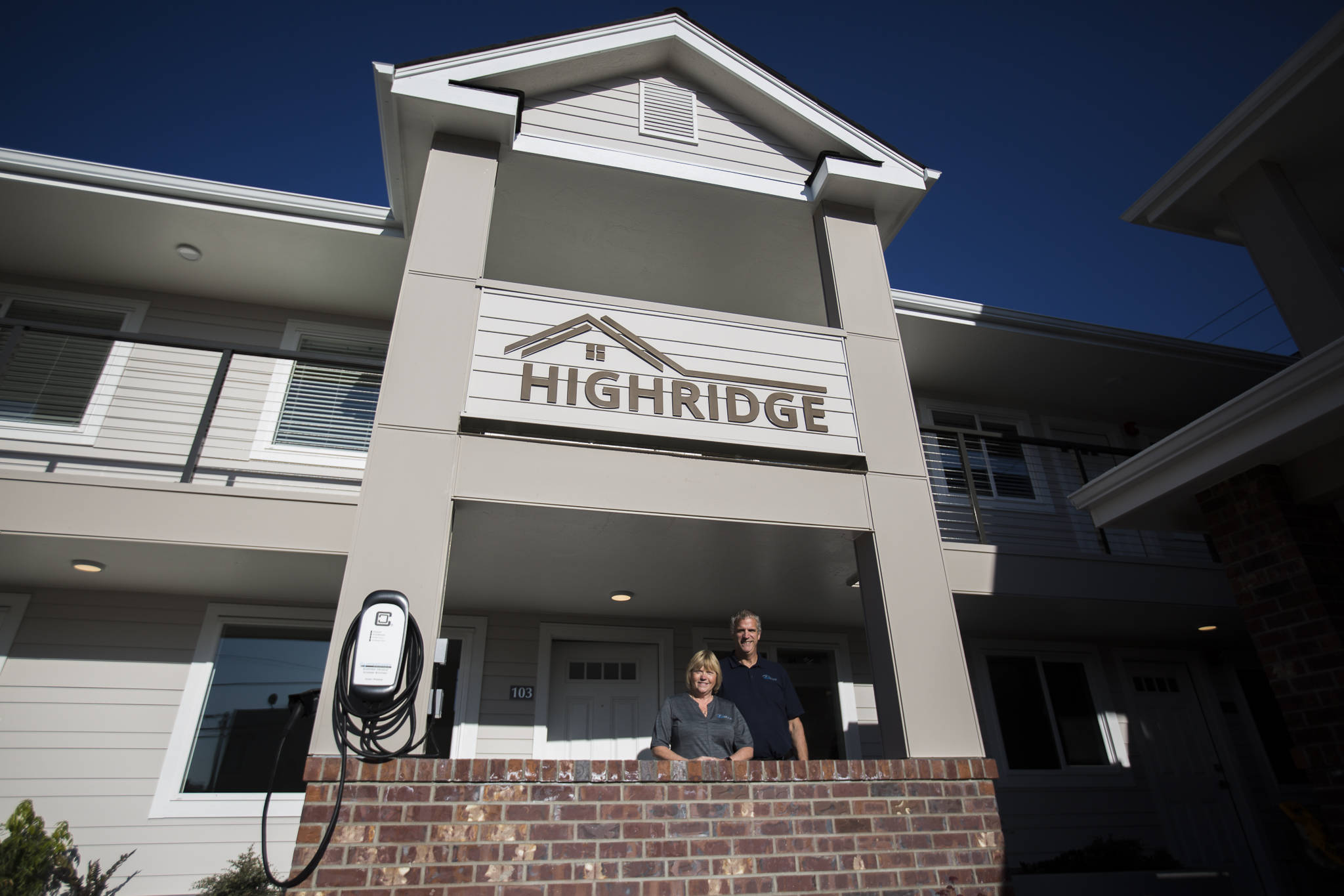 Rosy Addington (left) and Jim Addington stand outside the newly constructed Highridge Apartments on Nov. 29 in Everett. (Olivia Vanni / The Herald)