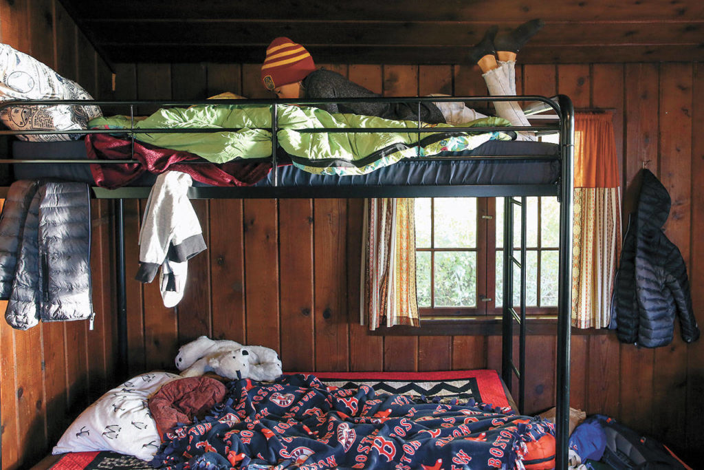 Emma Layton relaxes on her bunk at Cama Beach Historical Park. (Kevin Clark / The Herald)
