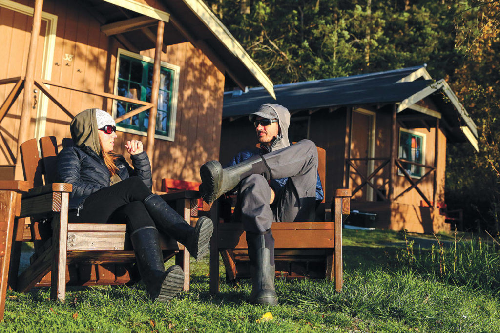 Michelle and Dan Layton of Indianola in Kitsap County enjoy a cool but sunny day on their annual trip to Cama Beach Historical State Park. (Kevin Clark / The Herald)
