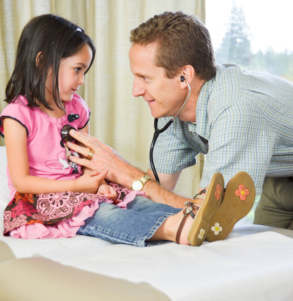 Dr. David Lindstrom works with a young patient at one of his two Western Washington Medical Group offices in Everett. He appreciates the ability to live in the same community in which he works, and get to know his patients well.