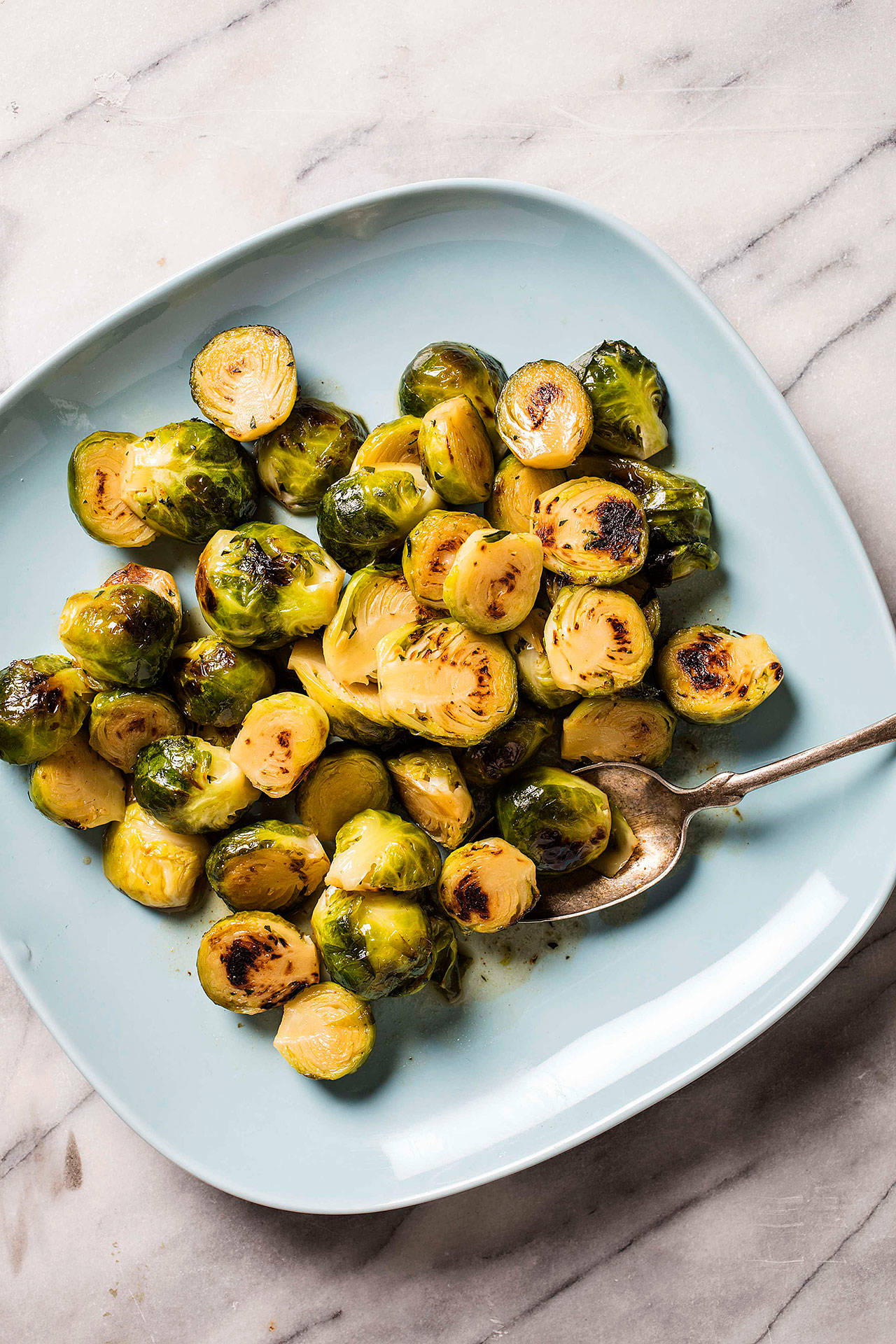 Maple syrup and cider vinegar combine to create a sweet-sour New England-style glaze for stovetop Brussels sprouts. (America’s Test Kitchen)