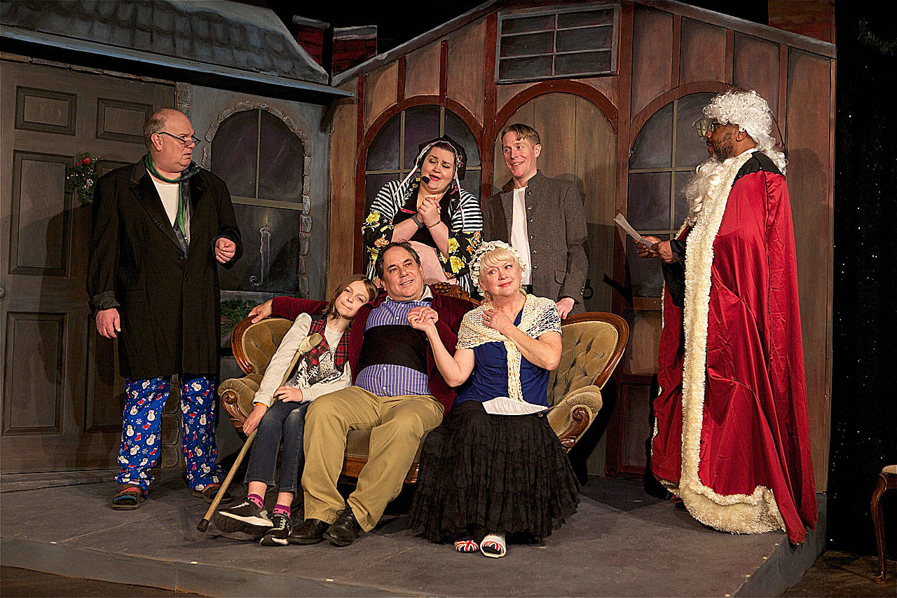 The madcap Christmas comedy “Inspecting Carol” is showing through Dec. 22 at the Phoenix Theatre in Edmonds. Pictured are, standing, Jay Jenkins as Larry, Stacey Gilbert as MJ, Ian Wight as Bart and Ray Miller as Walter, sitting, Oliver Sargent as Tiny Tim, John Fry as Phil and Susan Connors as Dorothy. (James Sipes)