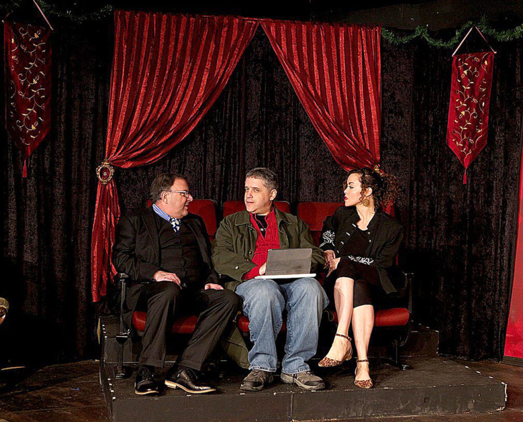 A scene from Phoenix Theatre’s production of “Inspecting Carol,” which was first staged in Seattle nearly 30 years ago. Pictured are Mark Abel as Kevin, Jim Snowden as Wayne and Amy Susynski as Zorah. (James Sipes)
