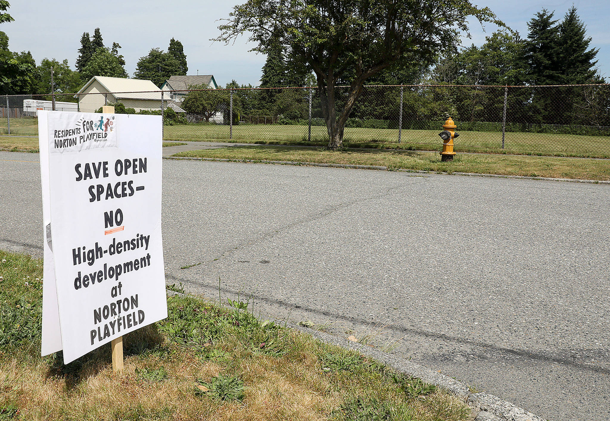 Signs popped over the summer up in the Port Gardner neighborhood against a proposal by the Everett School District and Housing Hope to build supportive housing on lot owned by the school district on Norton Avenue. (Lizz Giordano / The Herald)