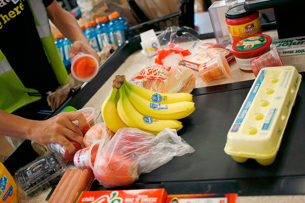 An employee bags groceries for a customer at a checkout counter inside a Kroger grocery store in Louisville, Kentucky, in June, 2017. The Trump administration has proposed rule changes to SNAP that would limit benefits for some and remove others from the program all together. (Luke Sharrett / Bloomberg file photo)