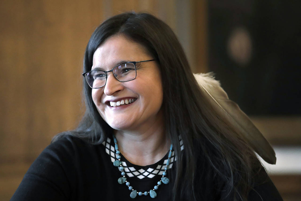 Whatcom County Superior Court Judge Raquel Montoya-Lewis, wearing an eagle feather honoring her Native American heritage, smiles as she speaks with media members after being named to the state Supreme Court on Wednesday in Olympia. (AP Photo/Elaine Thompson)