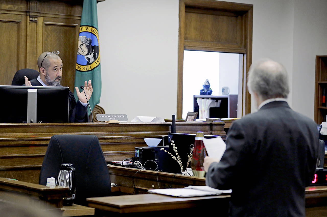 King County Judge Marshall Ferguson listens as Alan Copsey, an associate solicitor general of the state of Washington, speaks during a King County Superior Court hearing on Tuesday in Seattle. Lawyers for cities and counties across Washington state were in court to ask Ferguson to block Tim Eyman’s $30 I-976 car tab measure from taking effect. (AP Photo/Ted S. Warren, file)