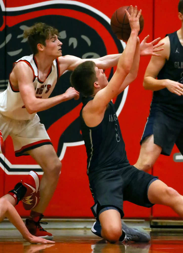 Glacier Peak’s Bobby Siebers (right) makes a basket from the floor with King’s Will Pohland defending Friday evening at King’s School in Shoreline. The Grizzles won 58-53. (Kevin Clark / The Herald)
