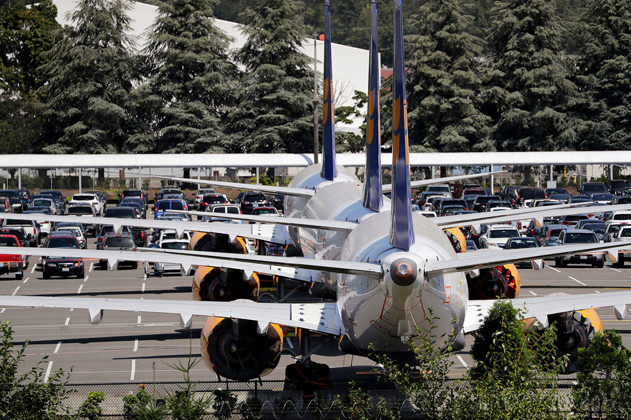 In this Aug. 15 photo, three grounded Boeing 737 Max airplanes, built for Icelandair, sit parked in a lot normally used for cars in an area adjacent to Boeing Field, in Seattle. (AP Photo/Elaine Thompson, File)