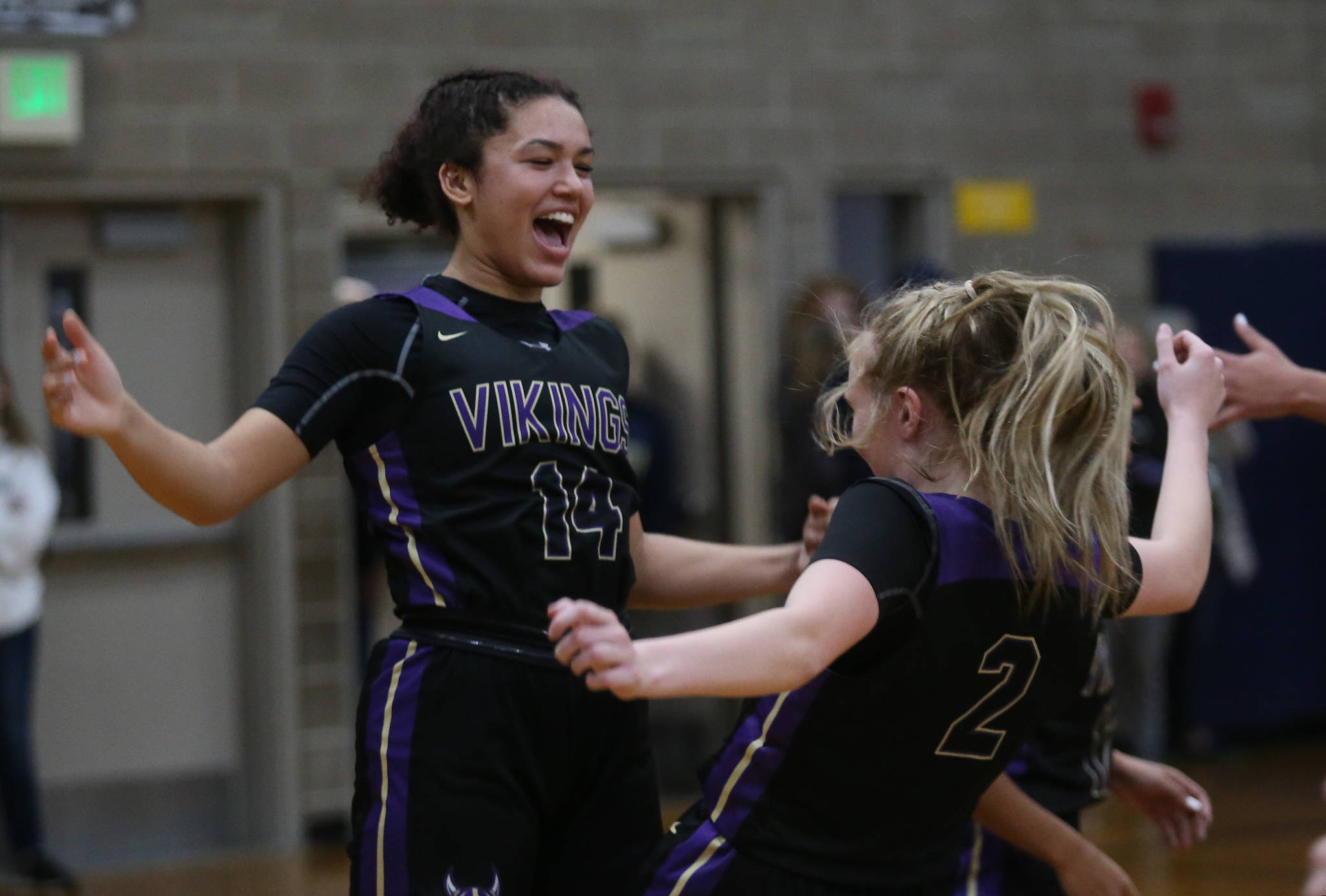 Lake Stevens’ Baylor Thomas (left) and teammate Chloe Pattison celebrate during a game against Arlington on Friday in Arlington. Lake Stevens won 57-54. (Andy Bronson / The Herald)