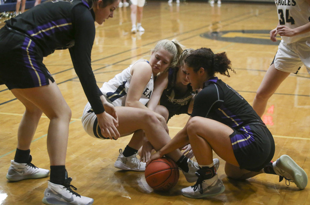 Players battled for a loose ball as the Arlington Eagles lost to the Lake Stevens Vikings 57-54 in a girls’ basketball game on Friday, Dec. 6, 2019 in Arlington, Wash. (Andy Bronson / The Herald)
