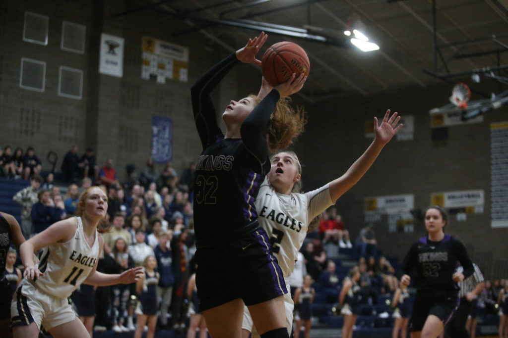 Lake Stevens’ Cori Wilcox goes for a shot at the basket as the Arlington Eagles lost to the Lake Stevens Vikings 57-54 in a girls’ basketball game on Friday, Dec. 6, 2019 in Arlington, Wash. (Andy Bronson / The Herald)
