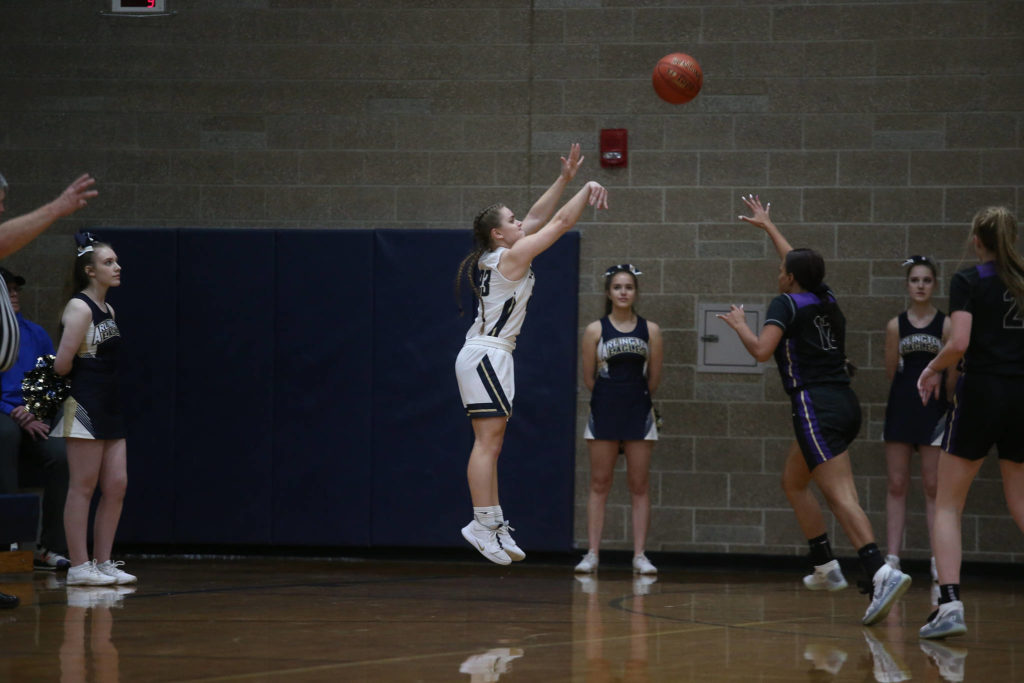 Arlington’s Allison DeBerry shoots a three-point shot as the Arlington Eagles lost to the Lake Stevens Vikings 57-54 in a girls’ basketball game on Friday, Dec. 6, 2019 in Arlington, Wash. (Andy Bronson / The Herald)
