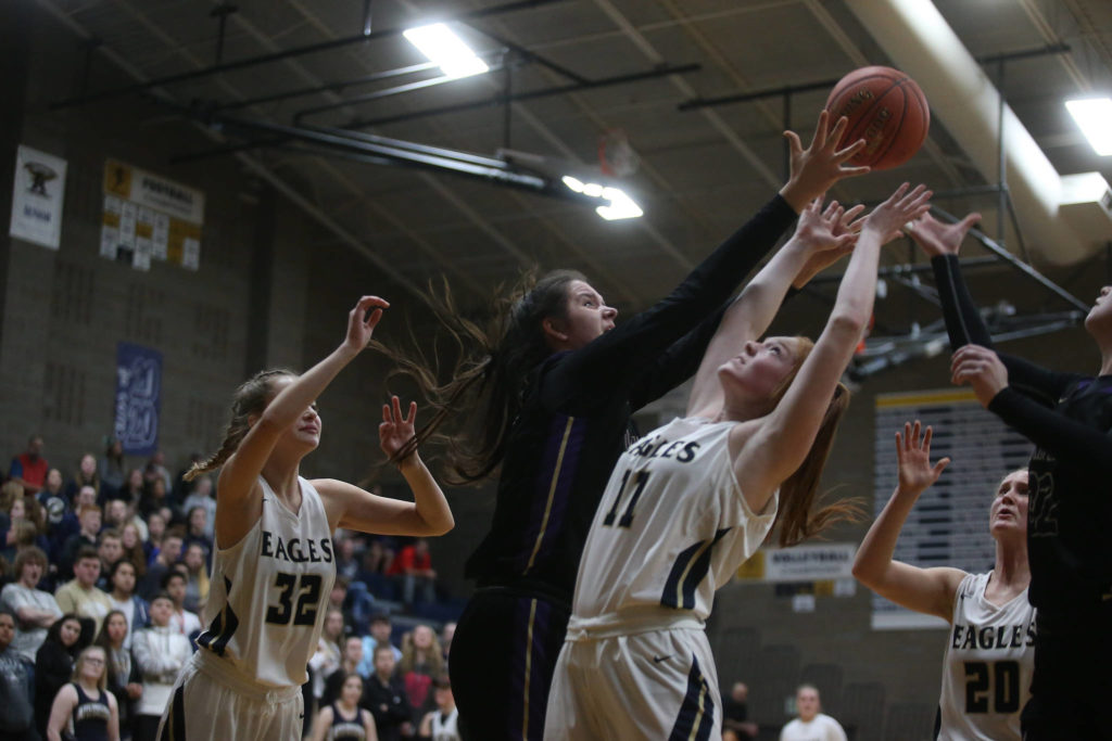 Lake Stevens’ Camille Jentzsch, center grabs for a rebound as the Arlington Eagles lost to the Lake Stevens Vikings 57-54 in a girls’ basketball game on Friday, Dec. 6, 2019 in Arlington, Wash. (Andy Bronson / The Herald)
