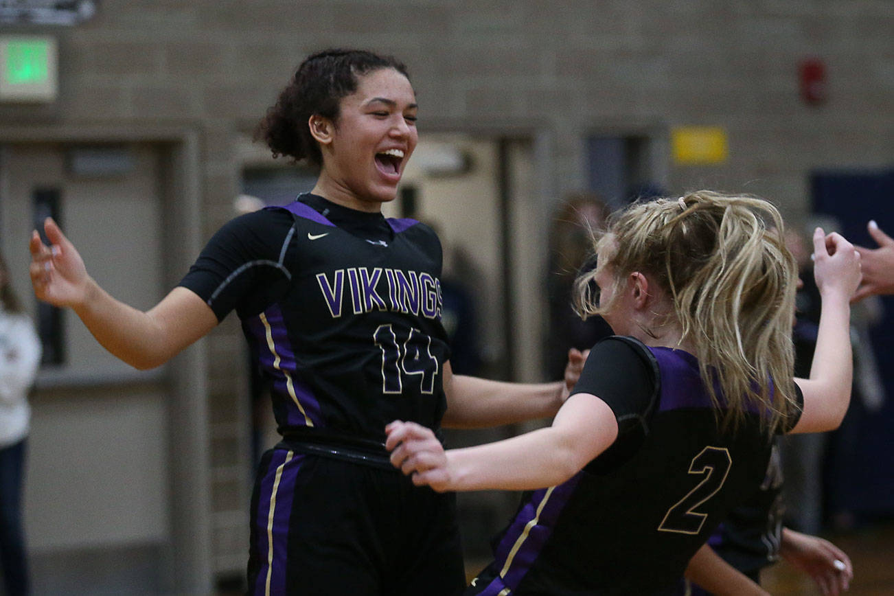 Lake Stevens’ Baylor Thomas and teammate Chloe Pattison celebrate as the Arlington Eagles lost to the Lake Stevens Vikings 57-54 in a girls’ basketball game on Friday, Dec. 6, 2019 in Arlington, Wash. (Andy Bronson / The Herald)