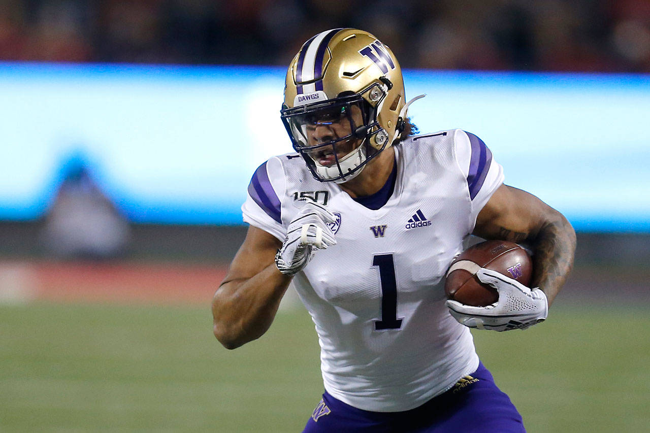 Washington tight end Hunter Bryant runs for a first down against Arizona during the first half of a game Oct. 12, 2019, in Tucson, Ariz. (AP Photo/Rick Scuteri)