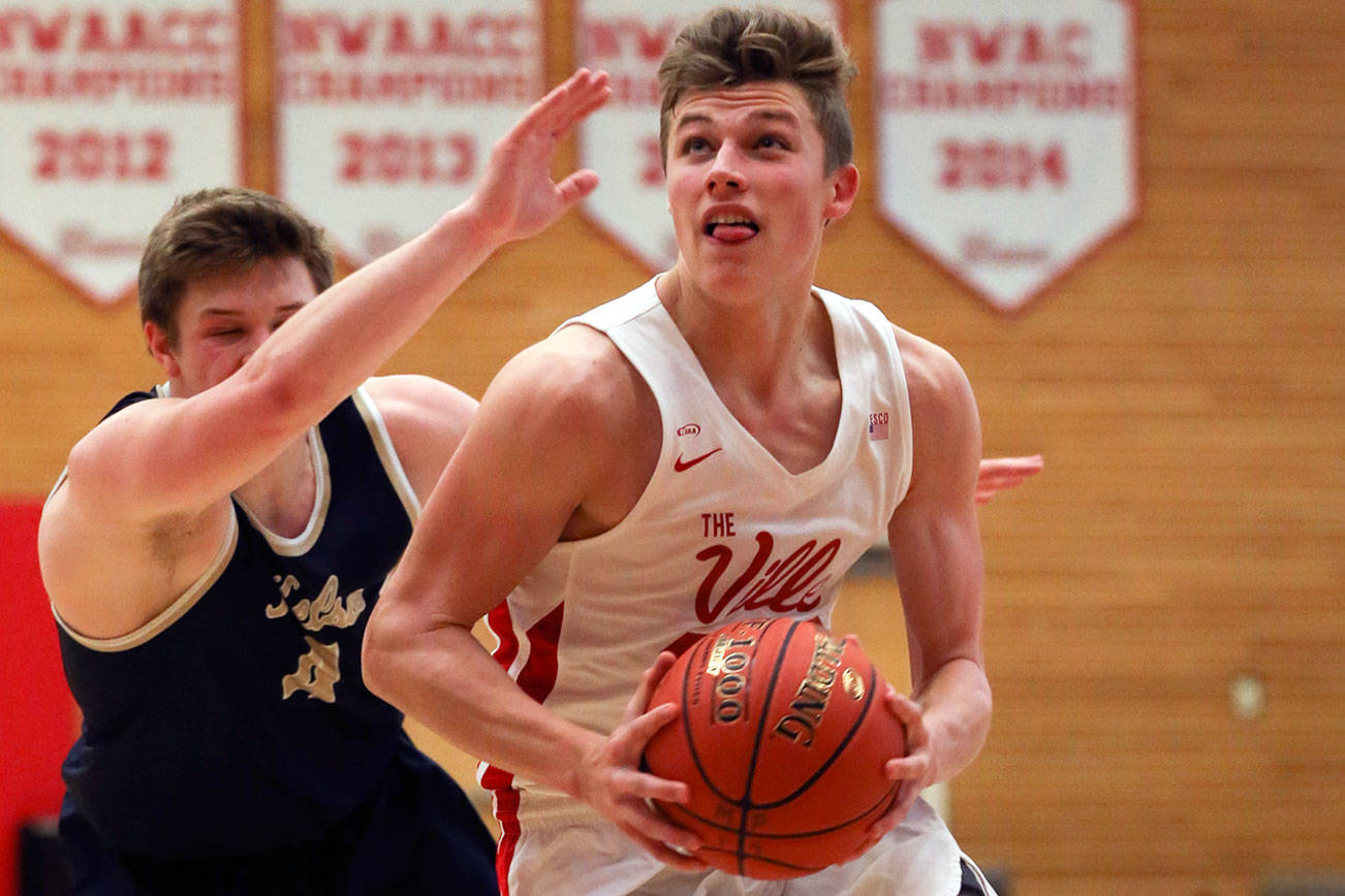 Marysville-Pilchuck’s Aaron Kalab drives to the basket with Kelso’s Riley Noah trailing Saturday afternoon at Everett Community College on February 22, 2019 in Everett. The Tomahawks won 72-51 to advance to the Tacoma Dome. (Kevin Clark / The Herald)