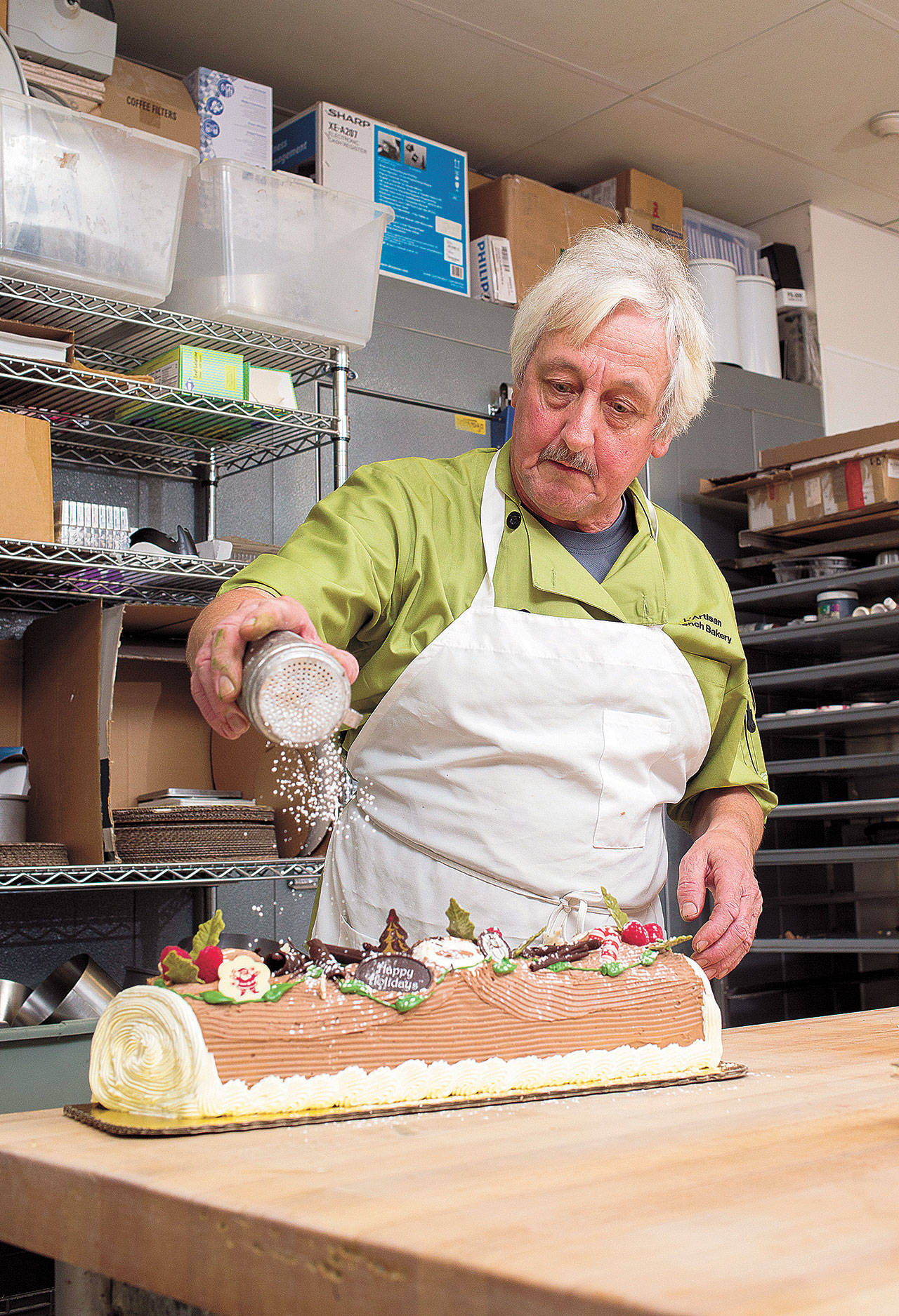 Jacky Lichtenthaler puts the finishing touches on a Yule log at L’Artisan. (Andy Bronson/ The Herald)
