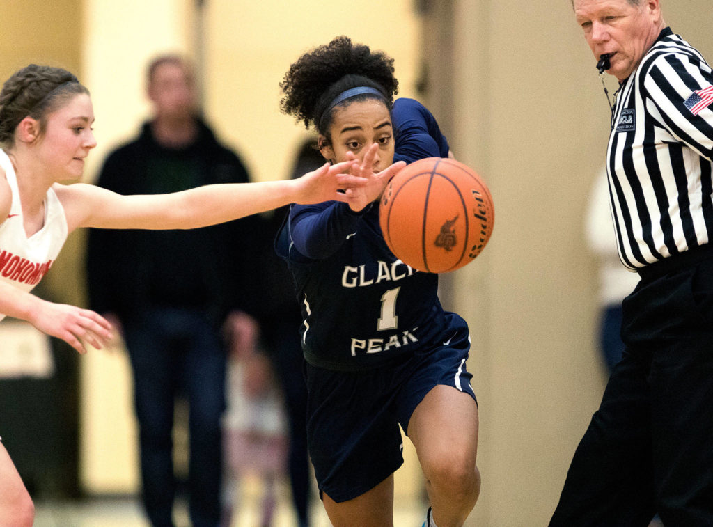 Glacier Peak’s Aaliyah Collins steals the ball from Snohomish’s Cheyenne Rodgers as Glacier Peak beat Snohomish 50-39 in a non-league girls’ basketball game on Dec. 9 in Snohomish. (Andy Bronson / The Herald)
